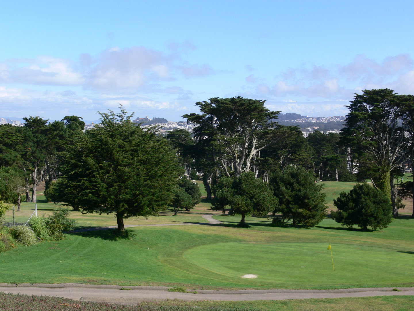 Tree-lined fairways and greens at Lincoln Park Golf Course overlooking San Francisco Bay